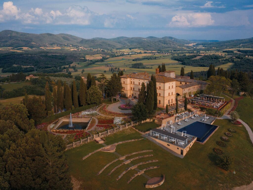 An overhead view of Castello di Casole with the old Roman amphitheater and infinity pool
