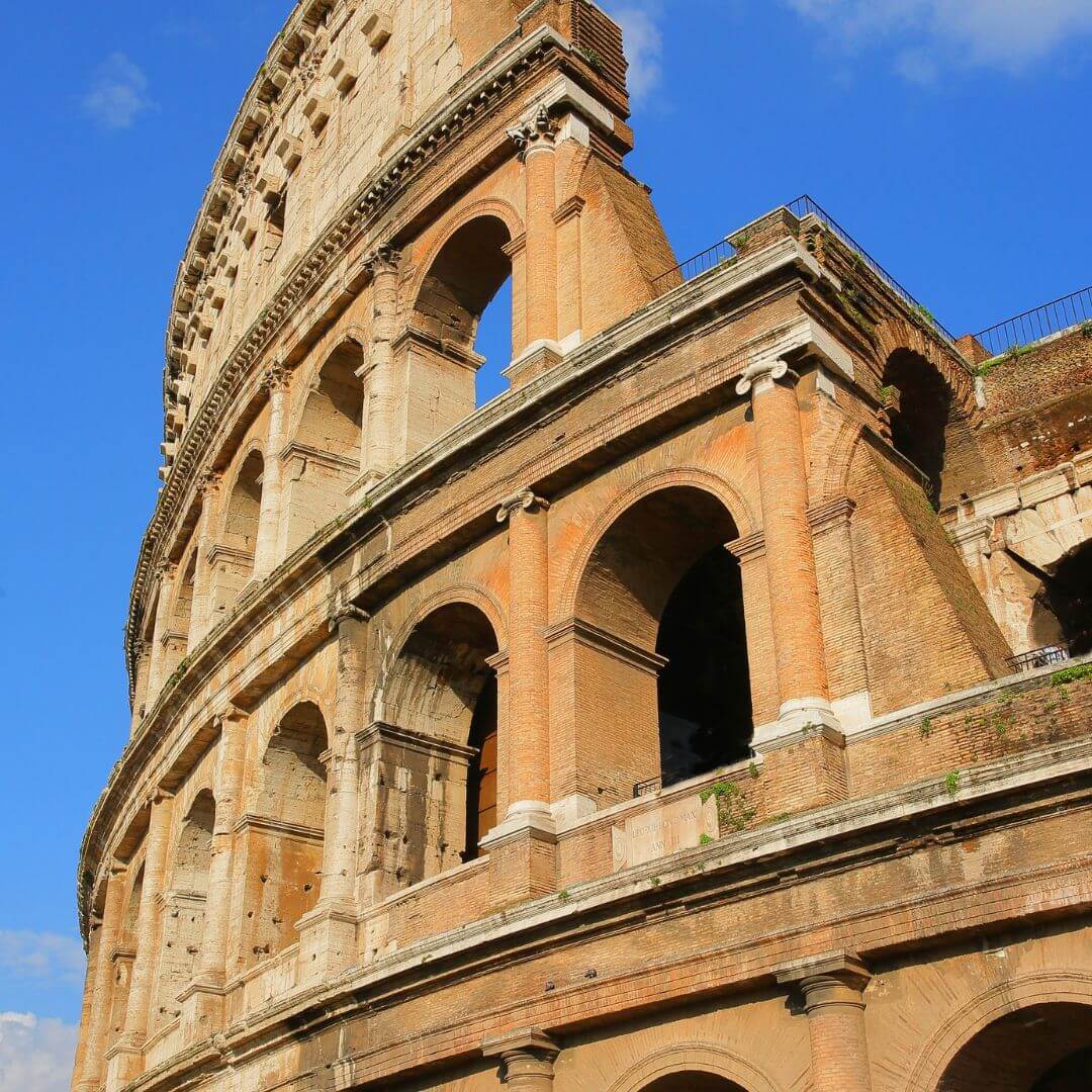 Exterior details on the Roman Colosseum in Rome Italy. You can clearly see the arches and columns, giving an idea of what the entire structure must have looked like.