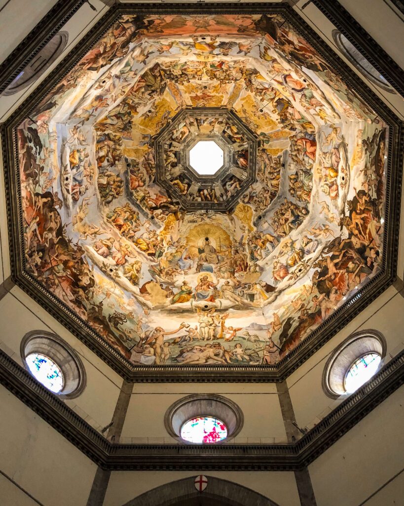 The paintings inside the dome of the Florence Cathedral. The paintings are arranged around the interior of the dome in rows, with vivid colors, illustrating Bible stories.
