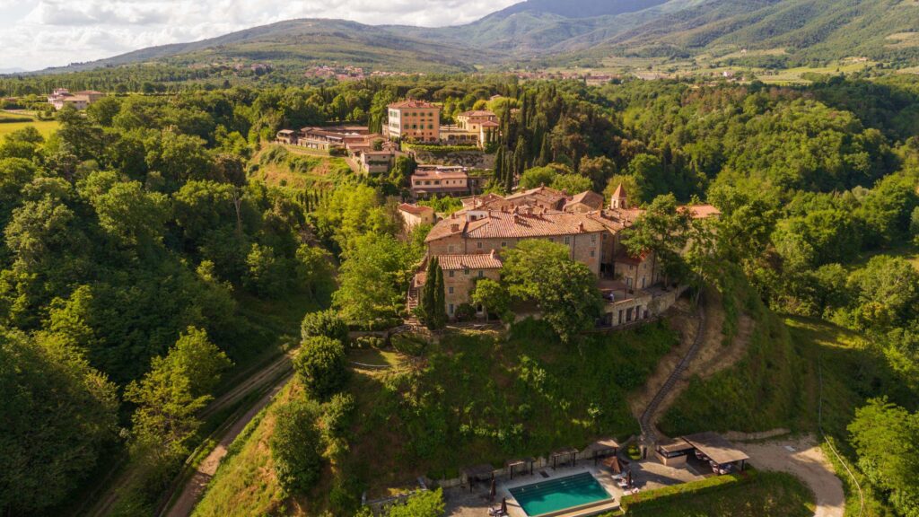 An overhead view of Il Borro, a luxury Tuscany hotel situated on the top of a hill.