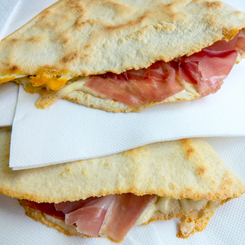 Proscuito di Parma and cheese wrapped in a piadina, a popular street food in Italy's Emilia Romagna region.