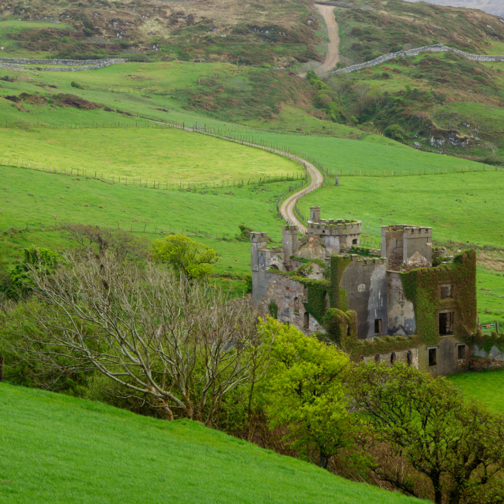 The moody ruins of Clifden Castle surrounded by green countryside in Northern Ireland