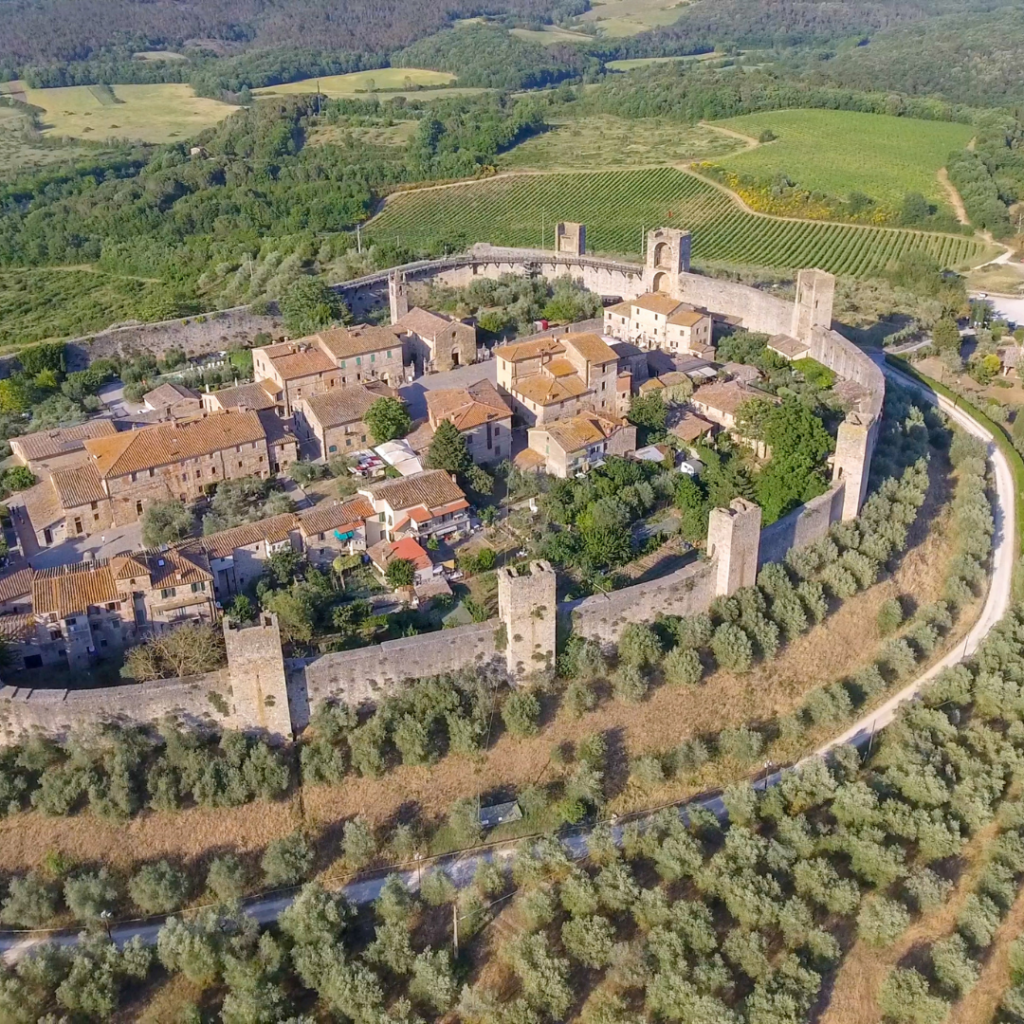 An aerial view of Monteriggioni with its ancient walls surrounding the old town