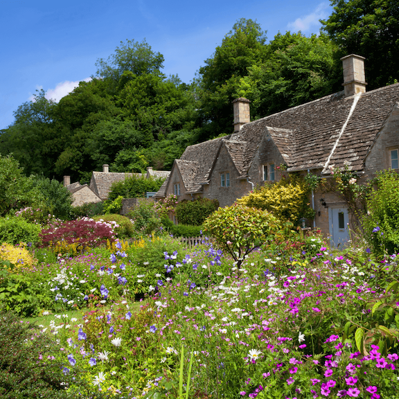 Summer blooms along Arlington Row in the Cotswolds village of Bibury