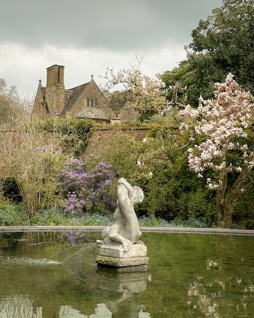 A beautiful fountain with Hidcote Manor behind