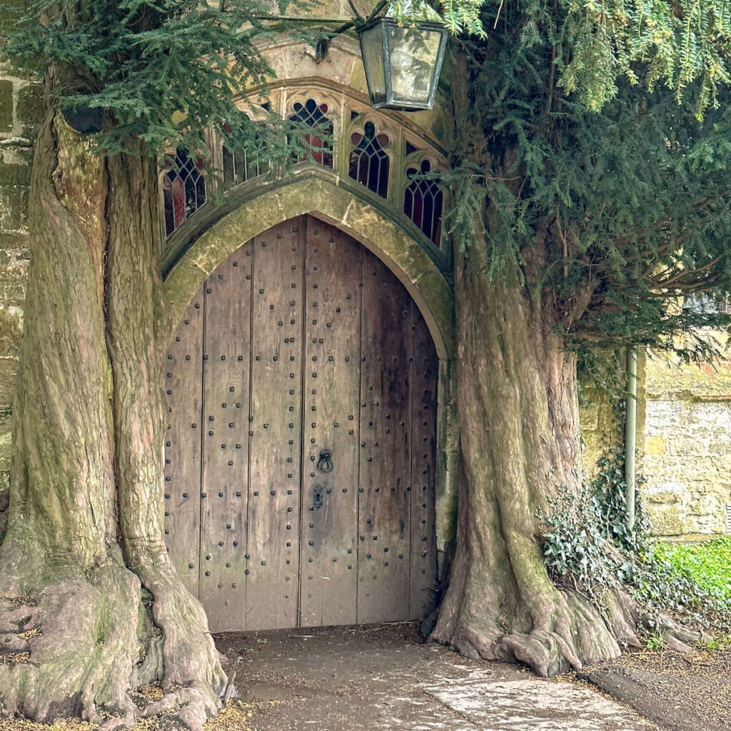 The yew tree framed doors of St Edwards Church in the Cotswolds town of Stow on the Wold