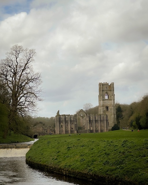 Fountains Abbey sitting alongside the river