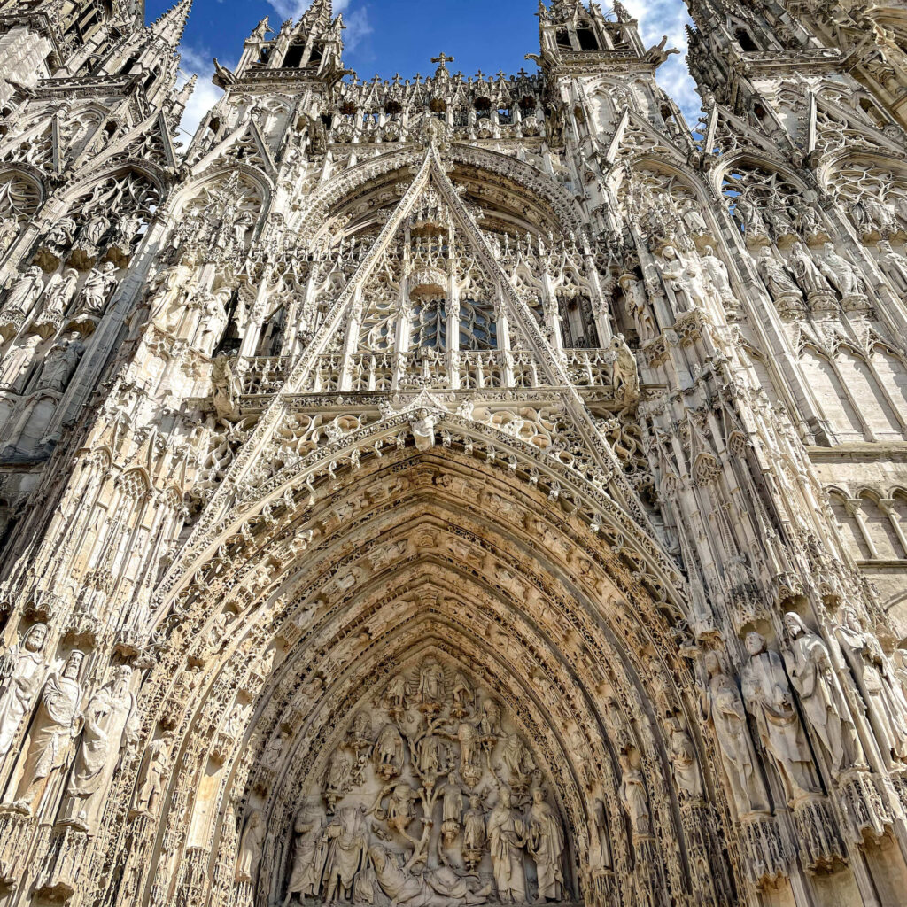 Studying the intricate carvings and statues of the Rouen Cathedral is one of the popular things to do in Rouen