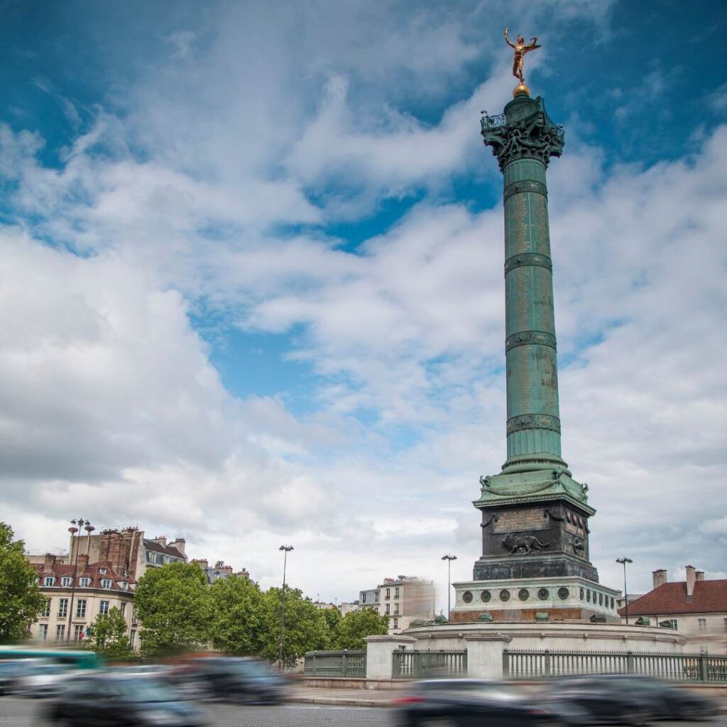 The column at Place de la Bastille against a blue sky filled with white clouds