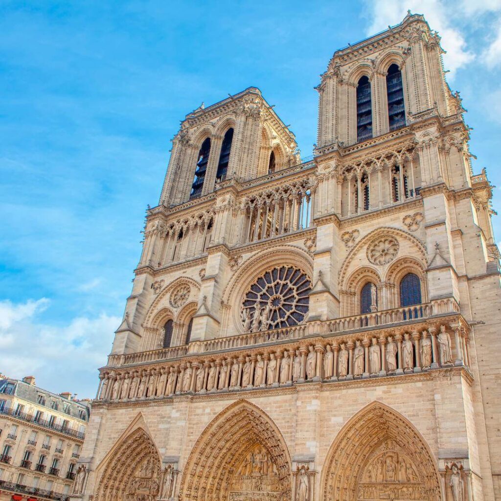 The front of Notre Dame Cathedral on a sunny blue-sky day