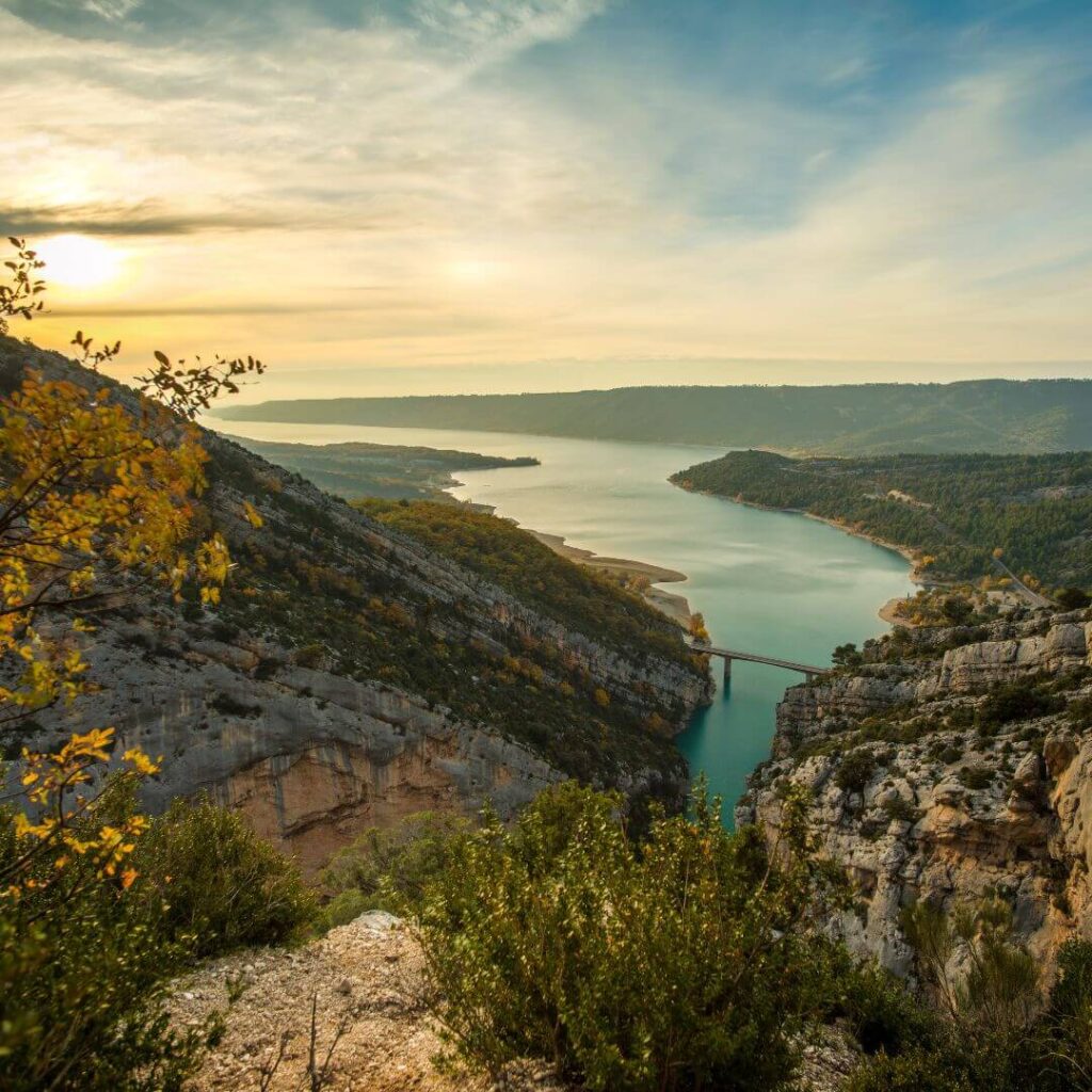 A view across the Gorges du Verdon with the river cutting through the middle as the sun is going down