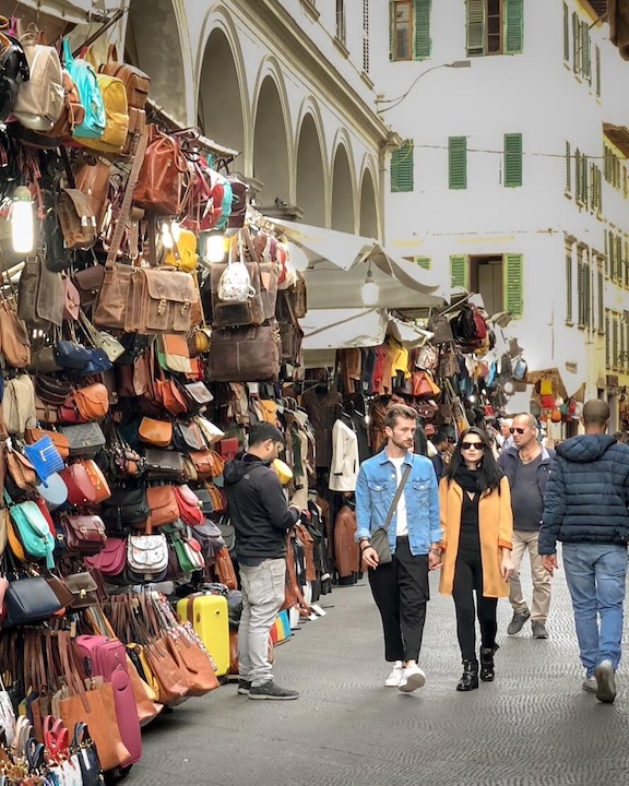 Vendors set up on the streets on the outskirts of the San Lorenzo market in one of the more touristed Florence neighborhoods