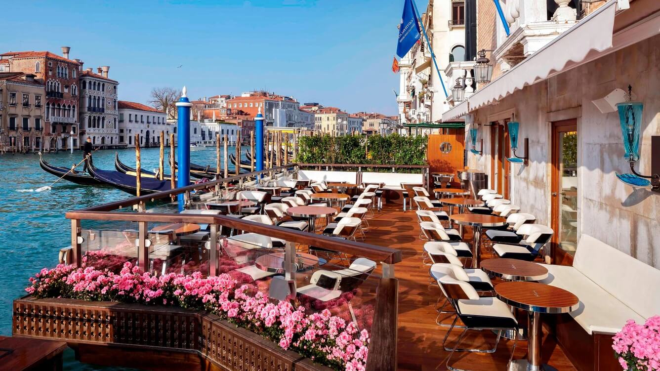 Tables and chairs along the Grand Canal at the Riva Lounge at The Gritti Palace, one of the best luxury hotels in Venice, Italy