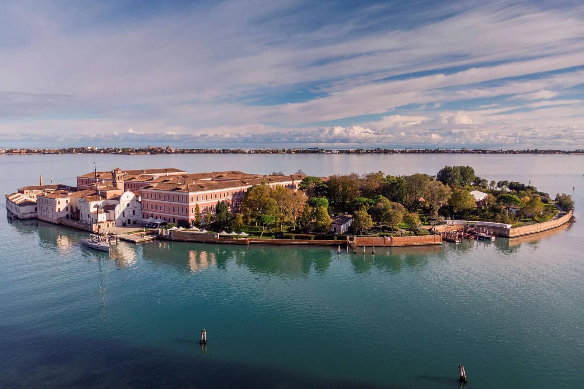 View of San Clemente island and the San Clemente Palace reflected in the calm waters of the Venetian lagoon